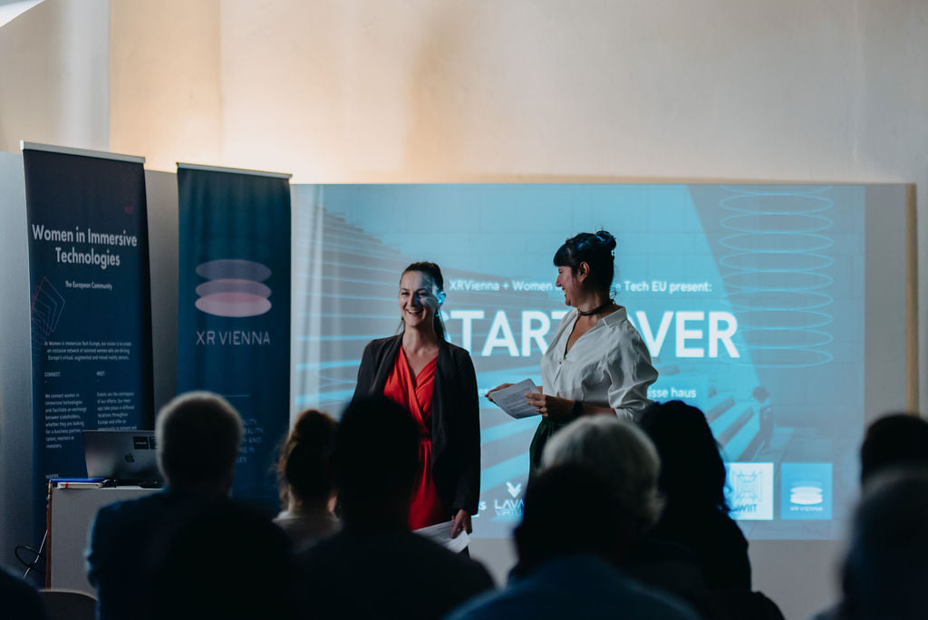 cofounder of Women in Immersive Tech Europe and XRVienna founder Gabriella Chihan Stanley on stage during an XRVienna Meetup